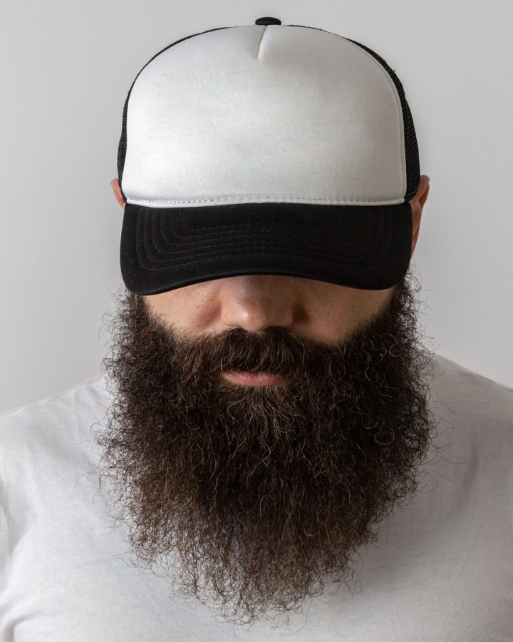Hipster handsome male model with beard. Baseball cap with space for your logo
